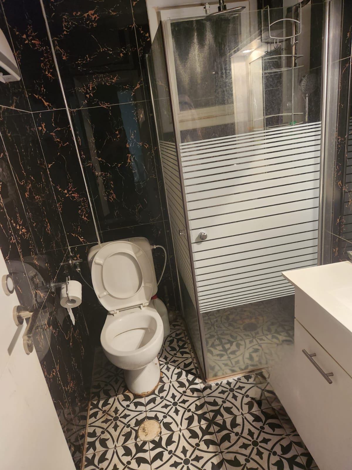 חדר הרחצה של יחידת ההורים עם מקלחון זכוכית